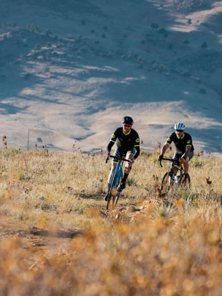 Three cyclists riding on mountain trail