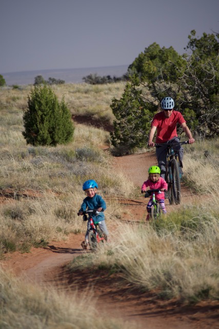 Doug Edmundson and his two kids riding on bike trail