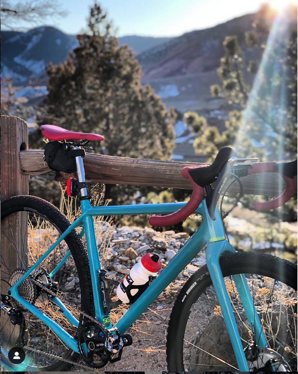 Bike resting against fence on mountain trail