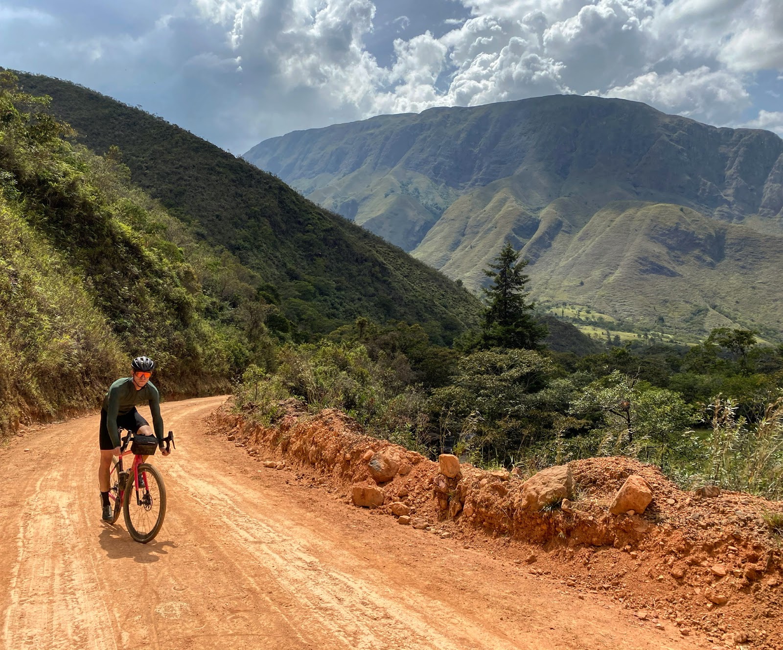 Cyclist riding on smoother roads at lower altitudes in Colombia
