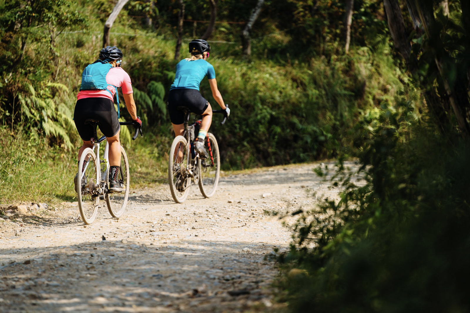 Two cyclists riding bikes on the gravel roads in Colombia